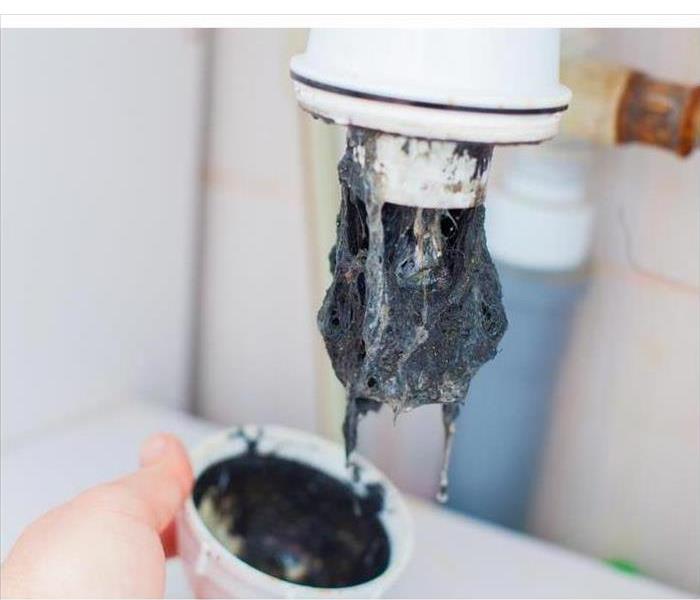 Clogged sink pipe. Unclog a drain from hairs and other stuff.