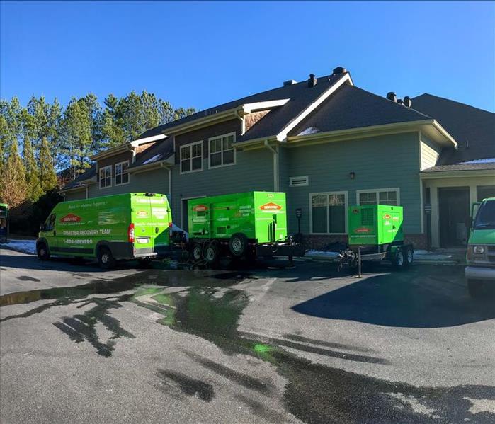 SERVPRO van and large loss equipment outside loss site.