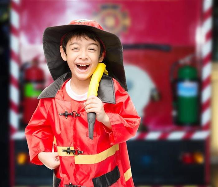 Little boy pretending as a firefighter
